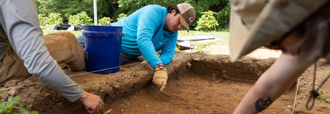 App State student researchers engage in an archaeology field school, using trowels to excavate a layer of soil just beneath the reach of plows at the university’s Blackburn Vannoy Estate and Farm in Ashe County.